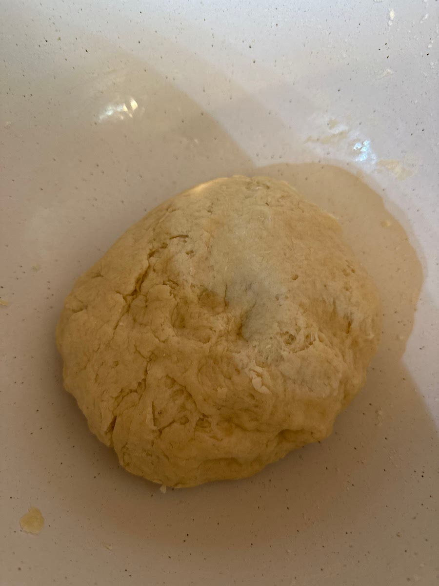 Slowly add 1 cup and maybe a 1-2 tbs of boiling hot water and knead dough together until you form a ball