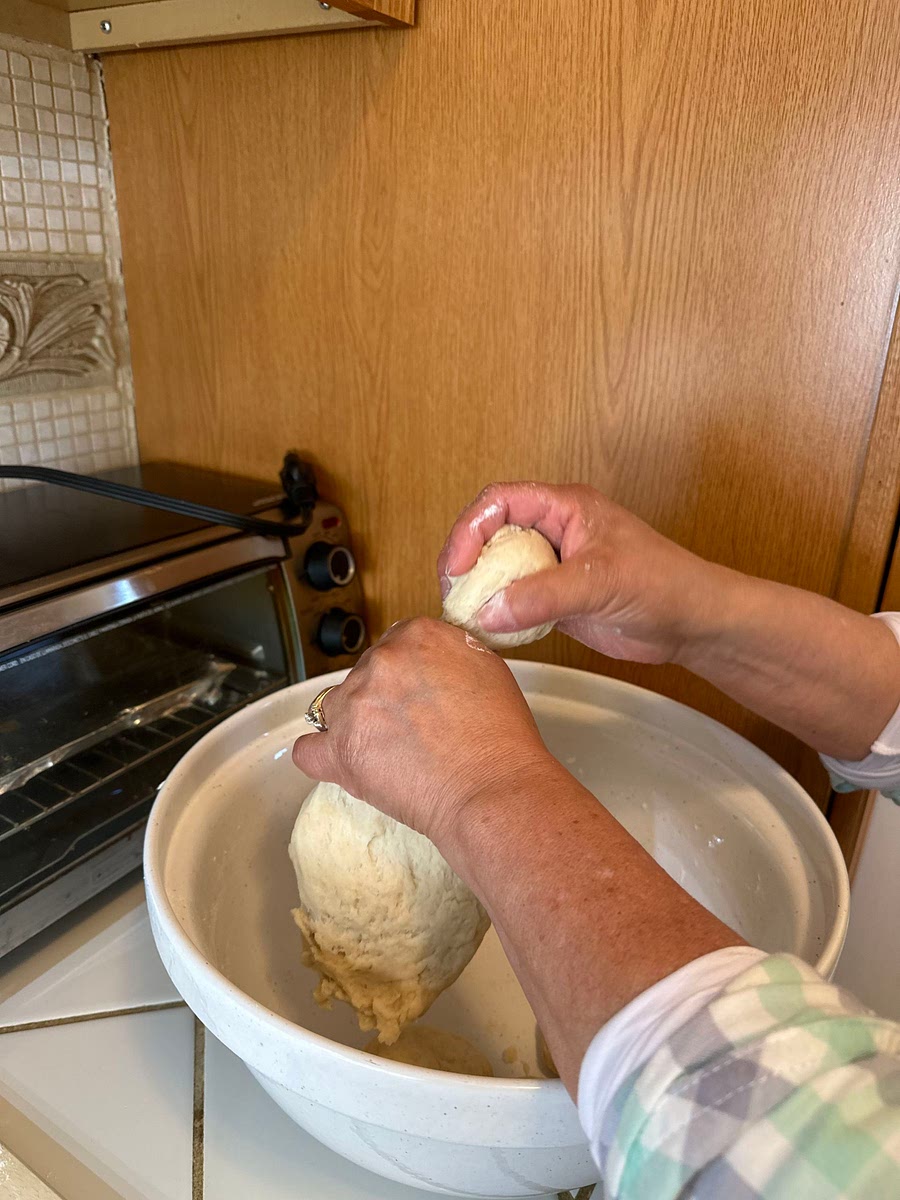 Pinch off a ball of dough and form it into a flat circle