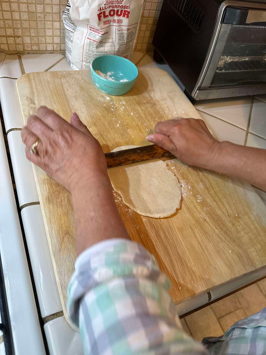 Roll out dough from the middle outwards, turning the dough when it feels like it isn’t stretching anymore