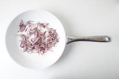 While the rice is cooking, peel (scrape the skin off with a teaspoon) and finely chop (or grate) the ginger. Peel and finely slice the red onion[s]. Heat a large, wide-based pan (preferably non-stick) with a drizzle of vegetable oil over a medium heat. Once hot, add 3/4 of the sliced onion (you'll use the rest later!) and cook for 3-4 min