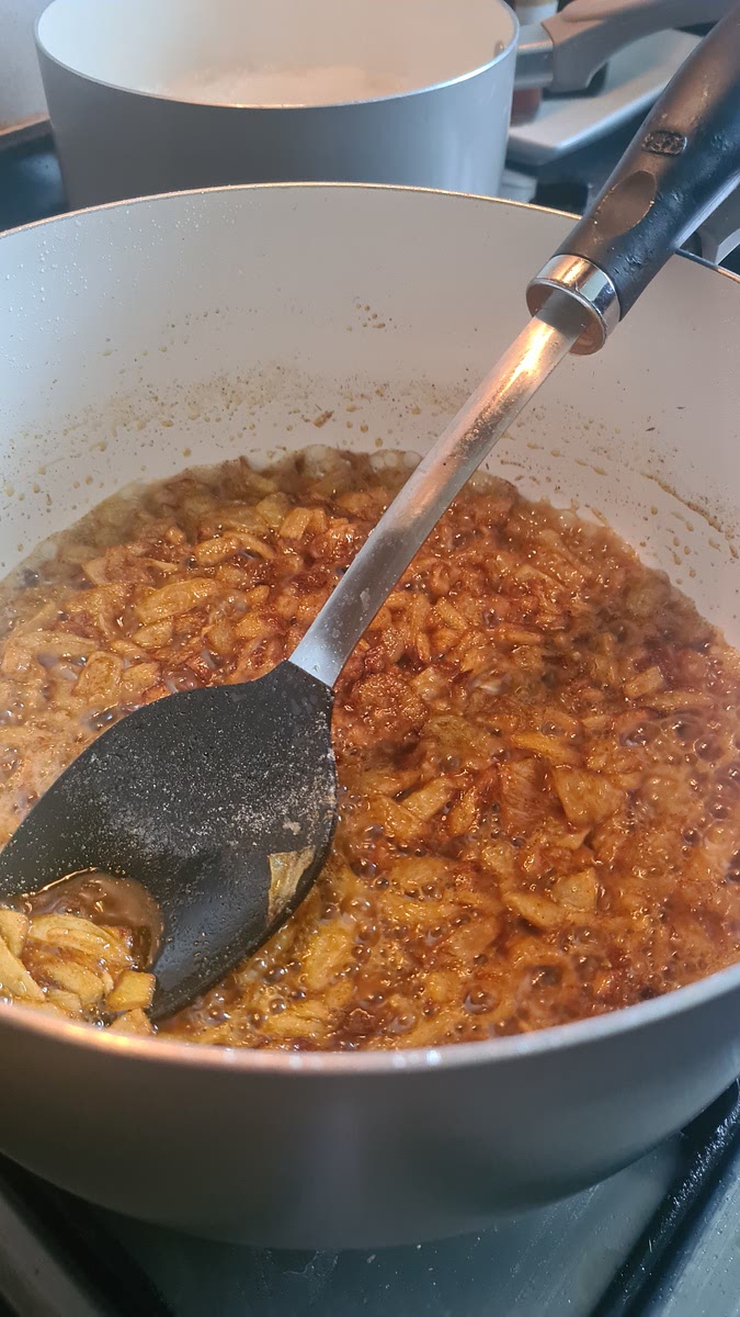 Put black pepper and salt in the pan, add 2 spoon cumin, 1 1/2 spoon coriander, half kashimere chili, half turmeric. Add the garlic and ginger