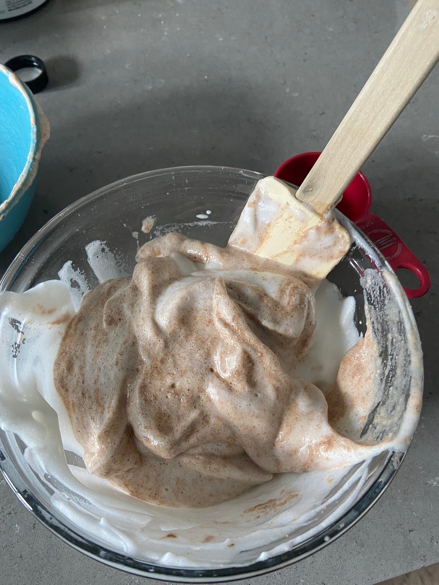 Fold in a third of egg whites until streaky, repeat with another third