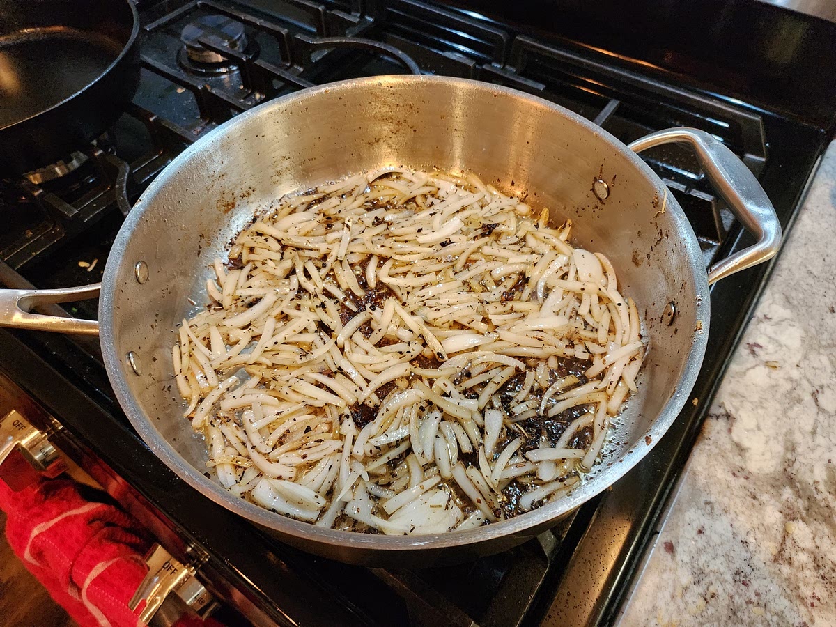 Cut the onion in wedges and place in the skillet used to sear the pork. Cook the onions until the juices remove the browning on the skillet. After it's done, transfer the onions to the slow cooker.