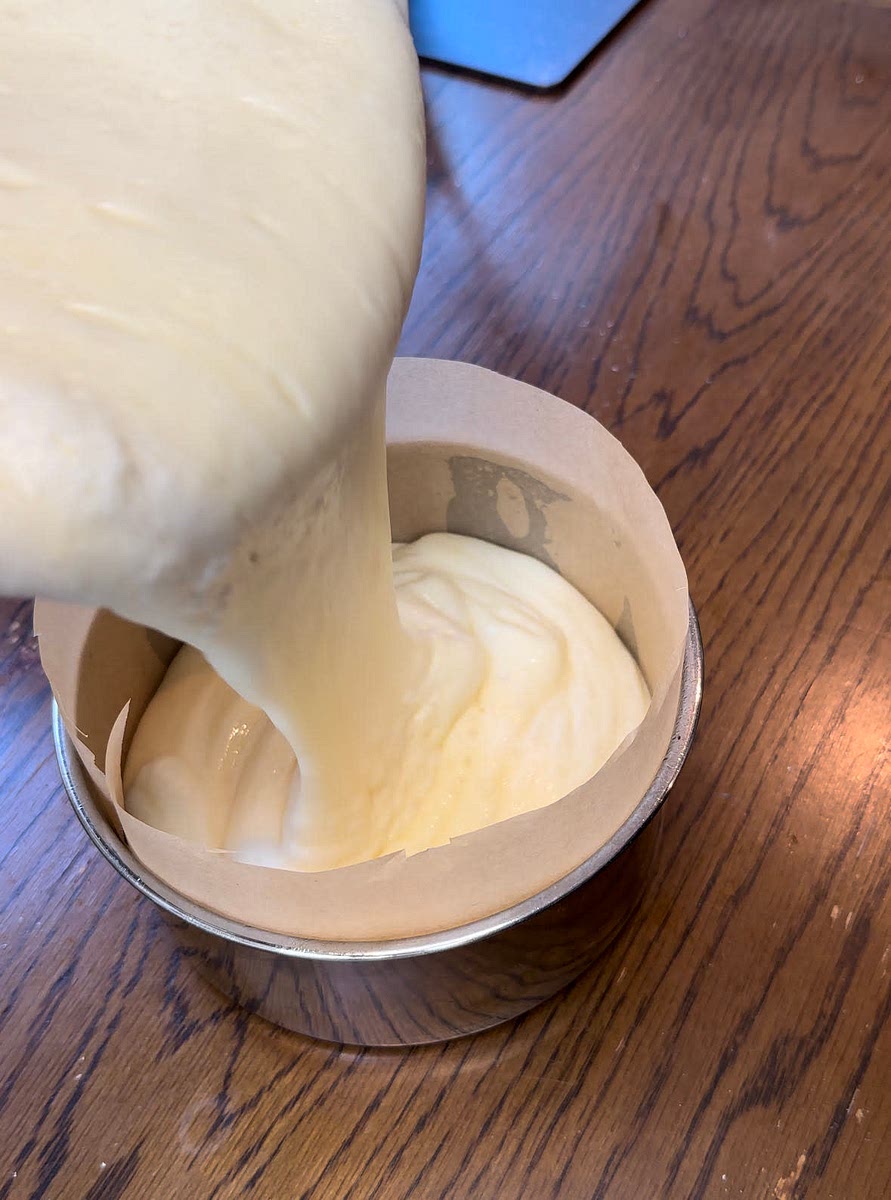 Divide and pour into three, 6x3 inch (ungreased, aluminum) cake pans equally.