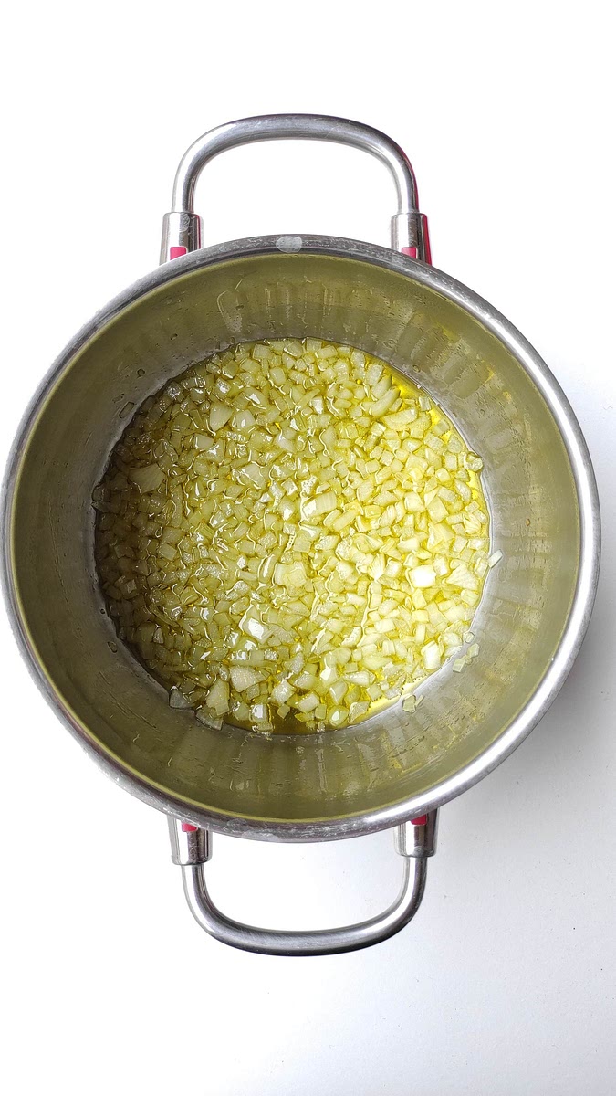 Heat olive oil in a large pan, add onion and sauté for 5 minutes or until it is soft over medium-high heat.