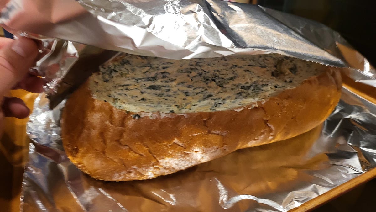 Fill the shell with the spinach dip when ready to cook. Wrap in aluminum foil, place on a baking sheet.