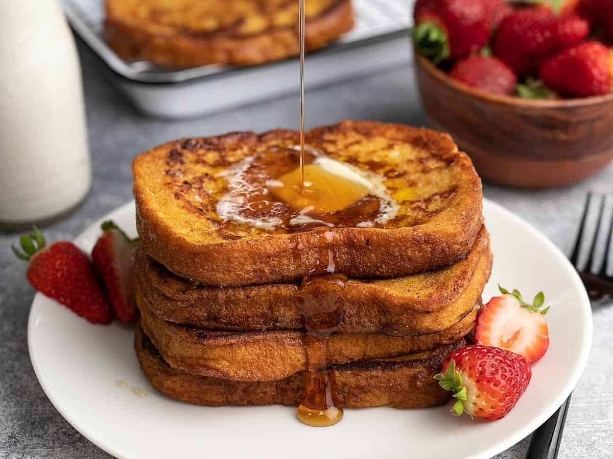 To serve plate up a stack of for slices of the French toast drizzle honey on top and then add about a tablespoon of butter on top to let it melt down the stack. Top with your choice as Eva berries or powdered sugar or even both depending on what you like.