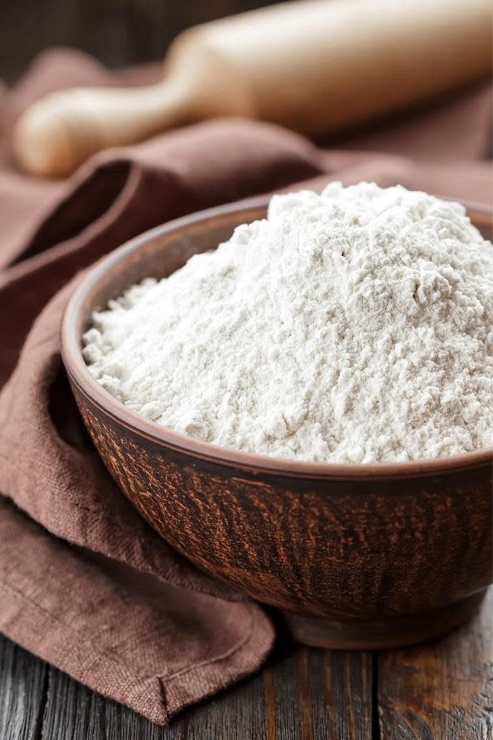 Into a bowl, pour in the self-raising flour. Remember to leave some for later as you will need it to roll out the dough!
