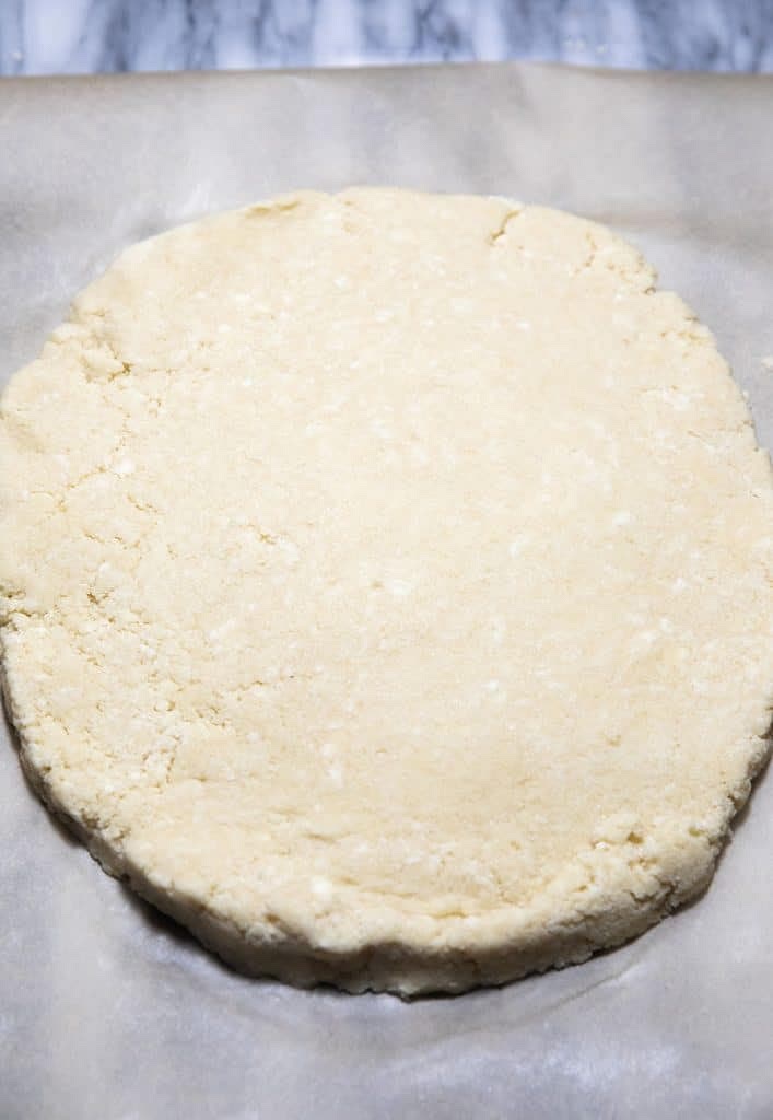 Sprinkle the extra flour onto a worktop and roll out the dough with your hands until it is 2cm thick.