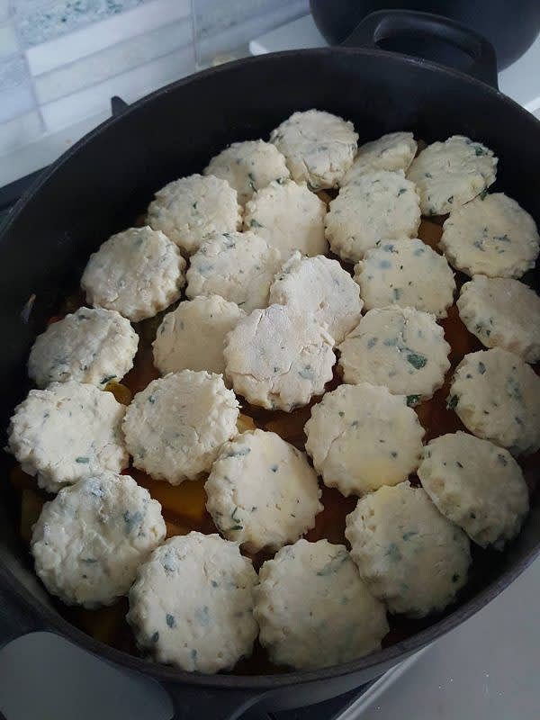 Place the cut out scones onto the apples in the oven-proof dish.