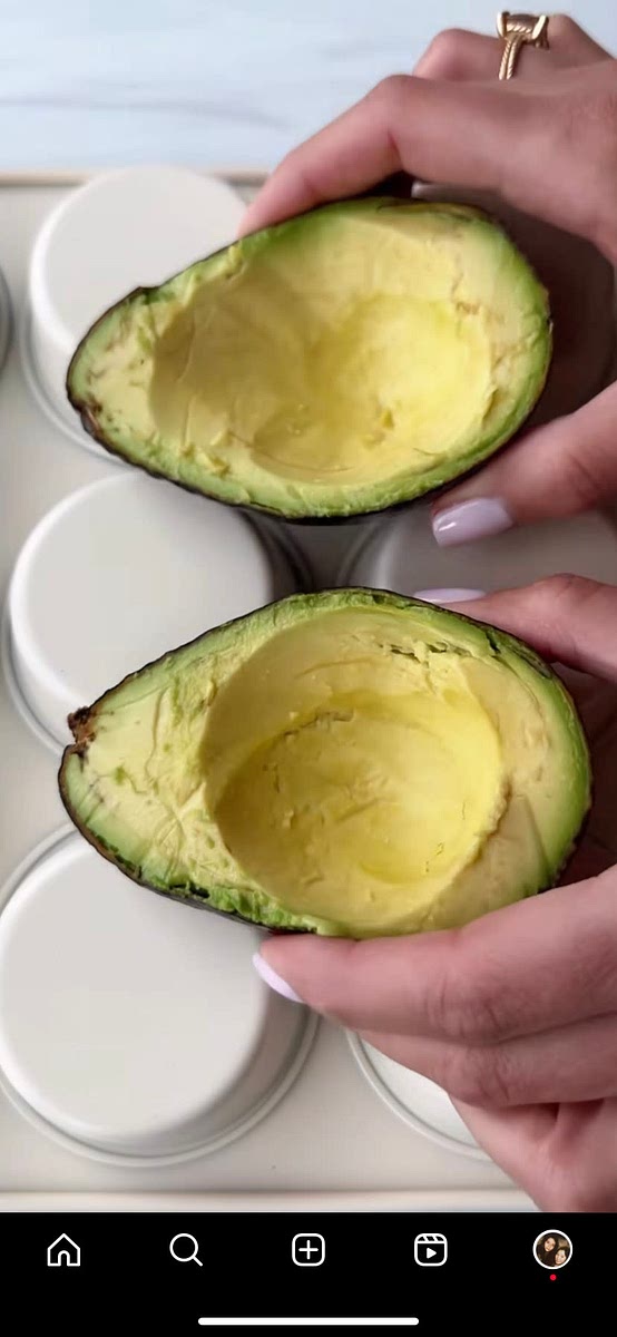 Use a spoon to scoop out some of the flesh of the avocado (scoop wide, not deep, otherwise egg will take longer to cook).
