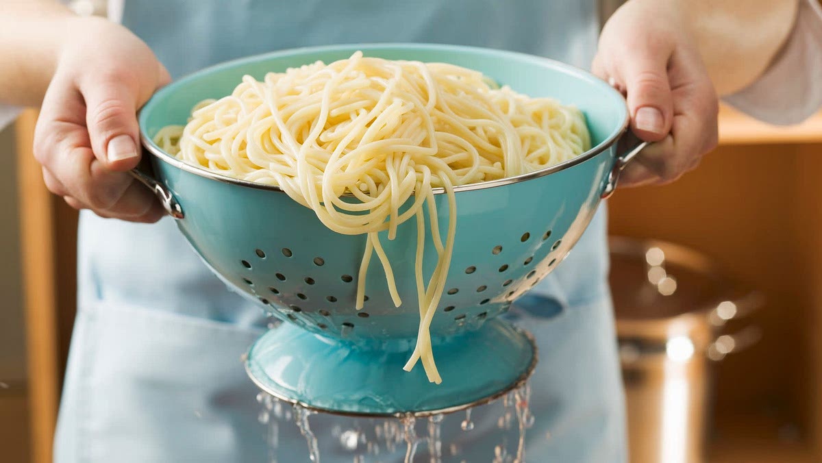 Once the Pasta is in the Colander, shake it over a sink to drain the pasta of water