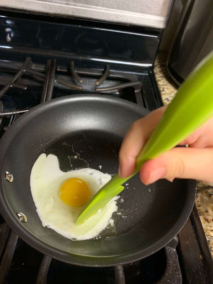 Fry the egg and try to make tiny dents into the egg for the egg to cook on the non cooked parts