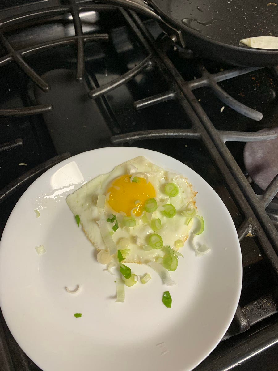 Put the egg on the plate and sprinkle with crushed basil if you want it to smell good.