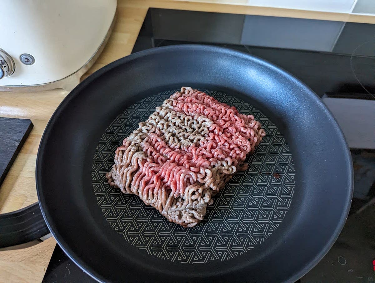 Put the mince in the frying pan, turn up the cooktop to the high setting and use the wooden spoon to mix it around until it turns into a brown colour