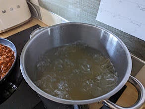Once the water has started boiling, pour the pasta in with some salt for flavour, then every 2 minutes mix the pasta around to make sure it doesn't stick to the sides