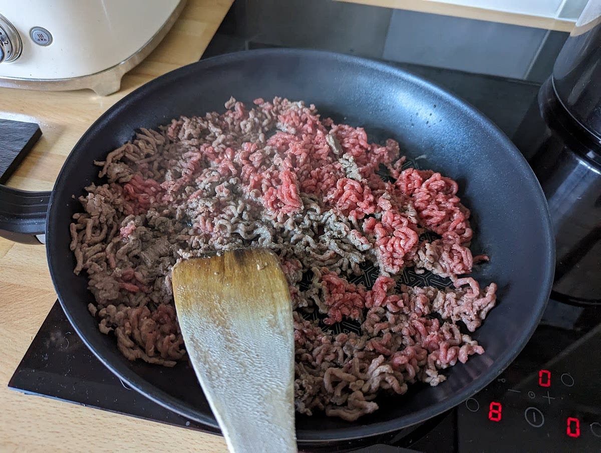 Once brown, use a normal spoon and empty the fat from the mince into the sink