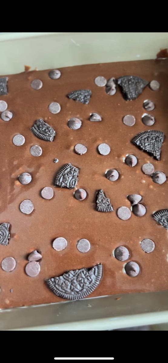 Place Oreos and chocolate chips on top, pressing them slightly into the batter. You can use as many Oreos as you desire.