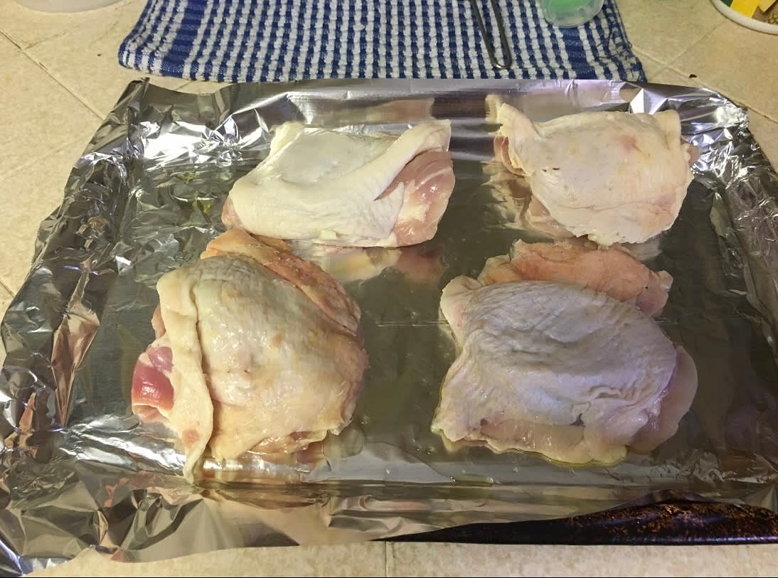 Line a baking pan with foil and drizzle unflavored coconut oil for each thigh you’ll place on it. Put four chicken thighs on the foiled baking pan.