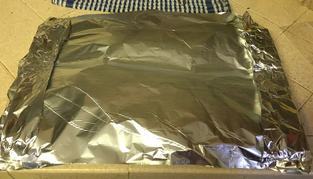 Loosely cover with foil, shiny side down. Make sure you do this in a way that will allow you to remove this lid, mid-cooking without too much difficulty.
