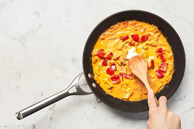 • Stir in coconut milk, ¼ cup water, 1 tsp sugar, 1 TBSP butter, and a big pinch of salt. (For 4 servings, use 1⁄3 cup water, 2 tsp sugar, and 2 TBSP butter.) Bring to a simmer, then reduce heat to low. Cook until thickened, 2-3 minutes more. TIP: Taste and add more sugar if you like a sweeter curry. • Add sour cream; stir to combine. Taste and season with salt and pepper. Turn off heat.