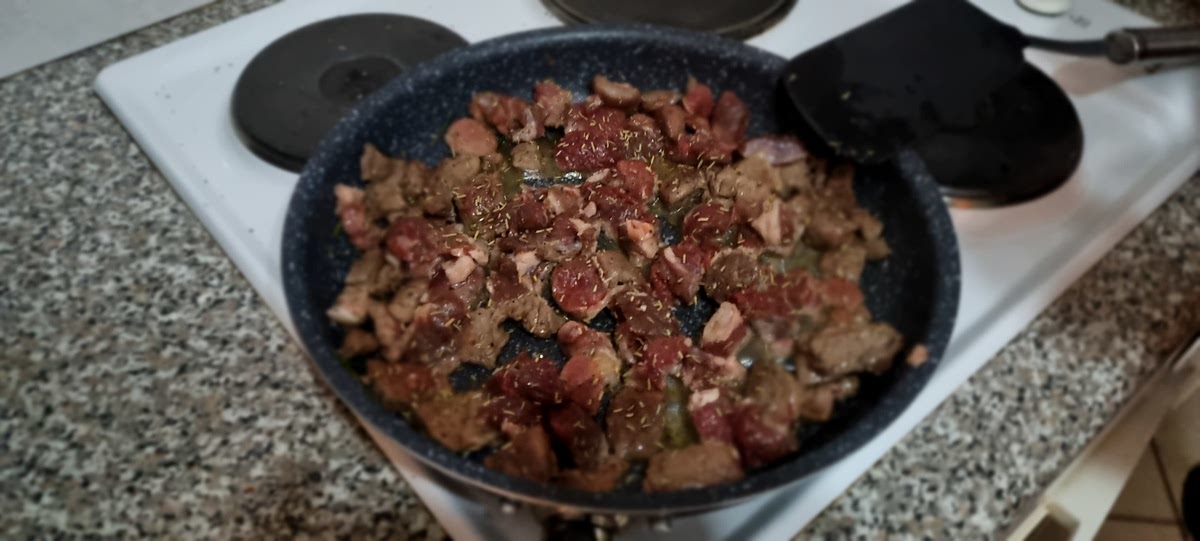 In a large casserole pot heat two tablespoons of olive oil and brown the lamb in batches. When the lamb is browned, remove from the pot and set aside.