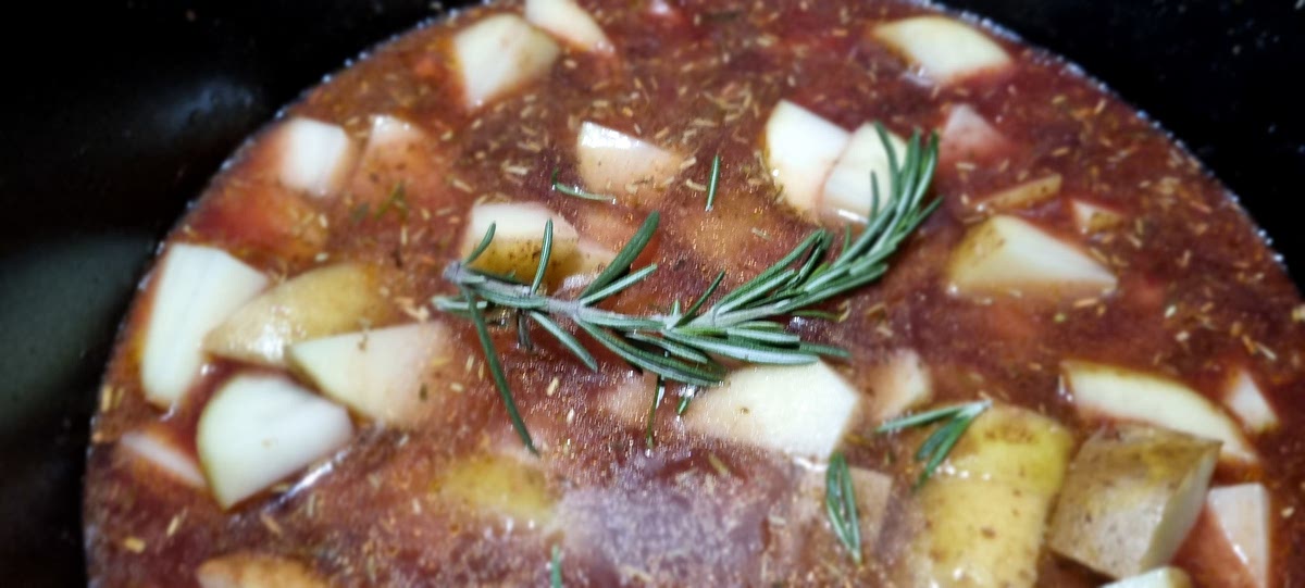 Next add the thyme, mustard, lamb stock, red wine, Worcestershire sauce, tomato paste, 250mls water and stir to combine.