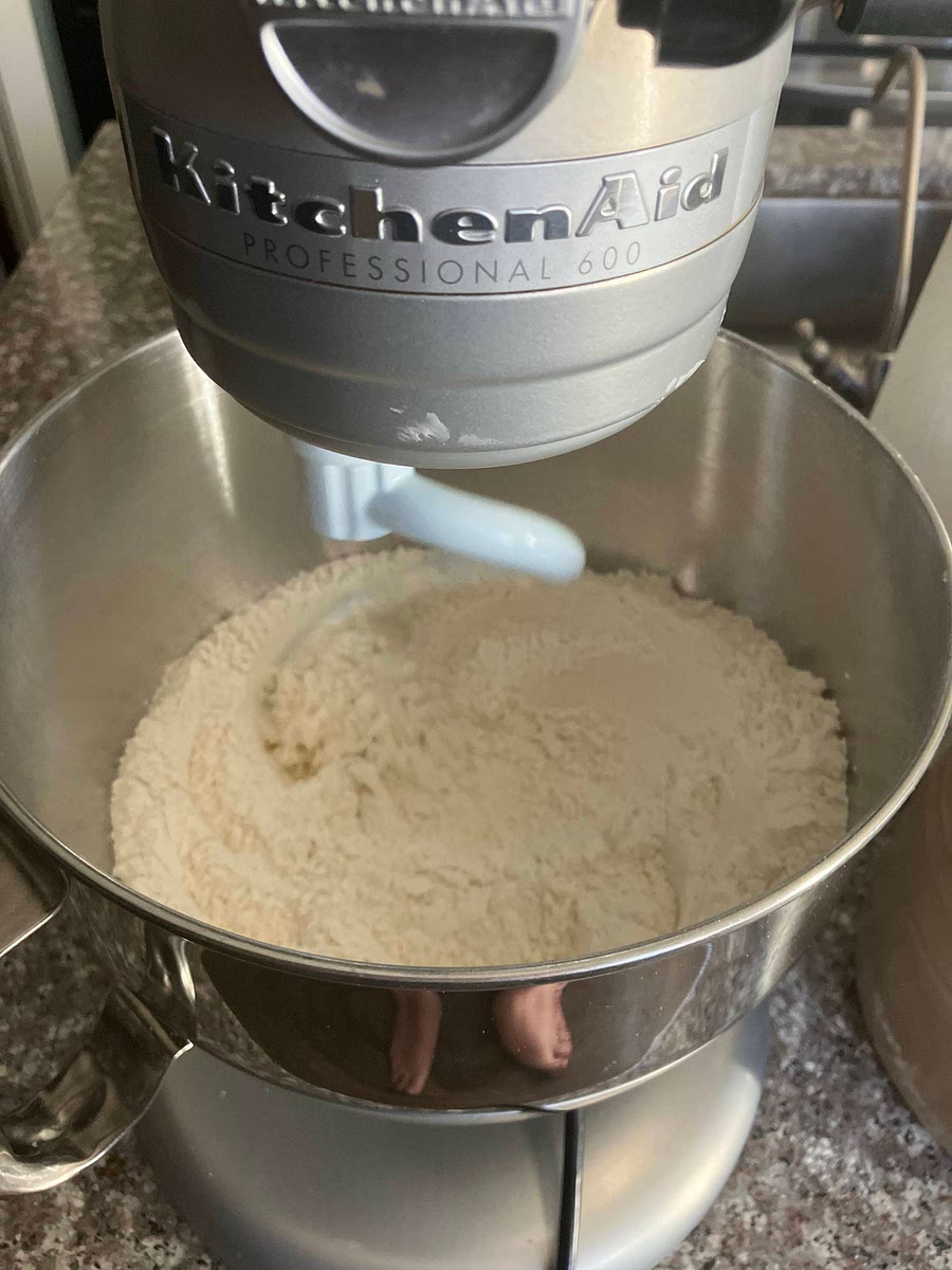 Prepare the dough by mixing the dry ingredients
If preparing ahead of time: use active dry yeast, if last minute use rapid rise.