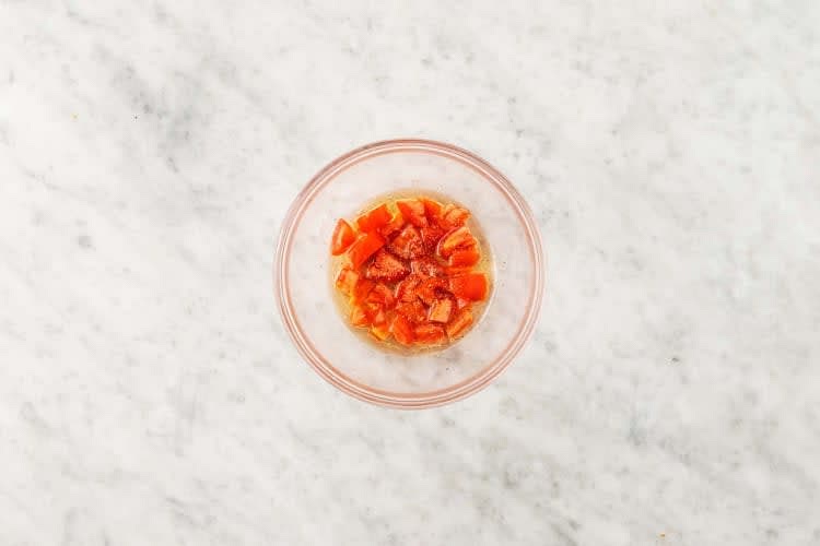 Whisk together vinegar, oil, and sugar in a medium bowl. Add tomatoes. Season with salt and pepper, then toss to coat.