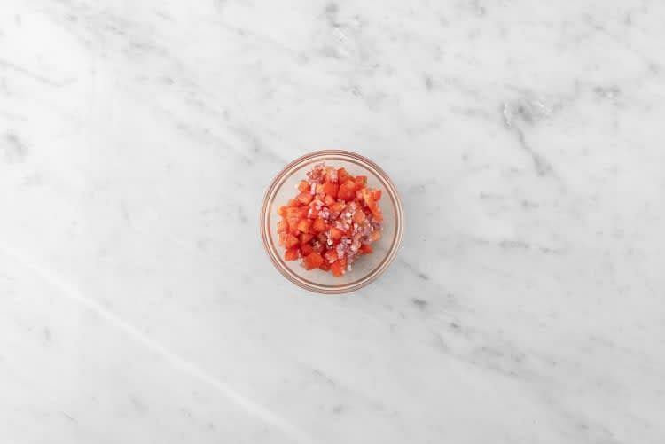 Peel, then mince shallot. Cut tomatoes into 1/4 inch pieces. Zest, then juice half the line. Cut the remaining lime into wedges. Combine tomatoes, shallots, lime zest, 1 tsp lime juice, and sugar in a small bowl. Set aside