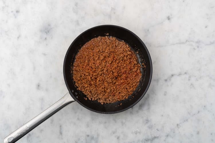 Add enchilada spice blend. Cook, stirring often, until fragrant (1 min). Season with salt and pepper. Add tomato sauce base and 1/4 cup water to the pan with meat. Stir to combine.