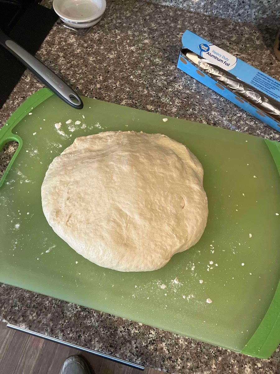 Take dough out of bowl and place on flat surface.