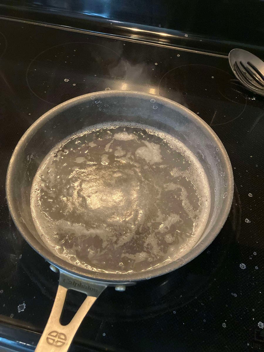 Bring the pot to a simmer/boil or until a layer of white fuzz is over the water