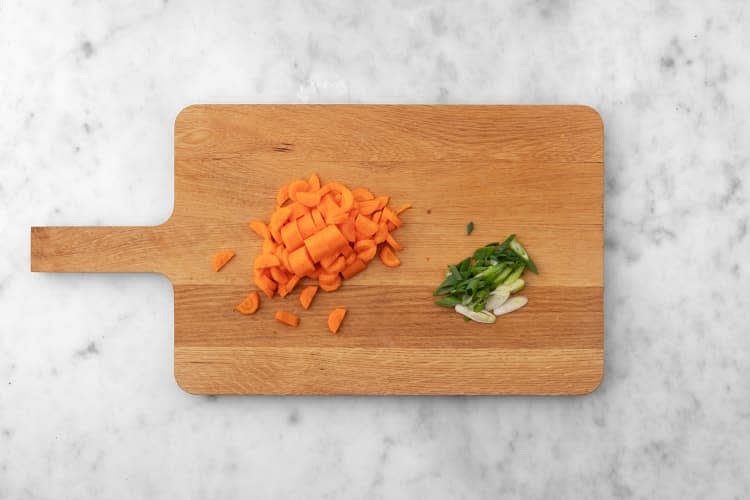 Meanwhile, peel, then halve carrot lengthwise. Cut into 1/4-inch half-moons. Thinly slice green onion.