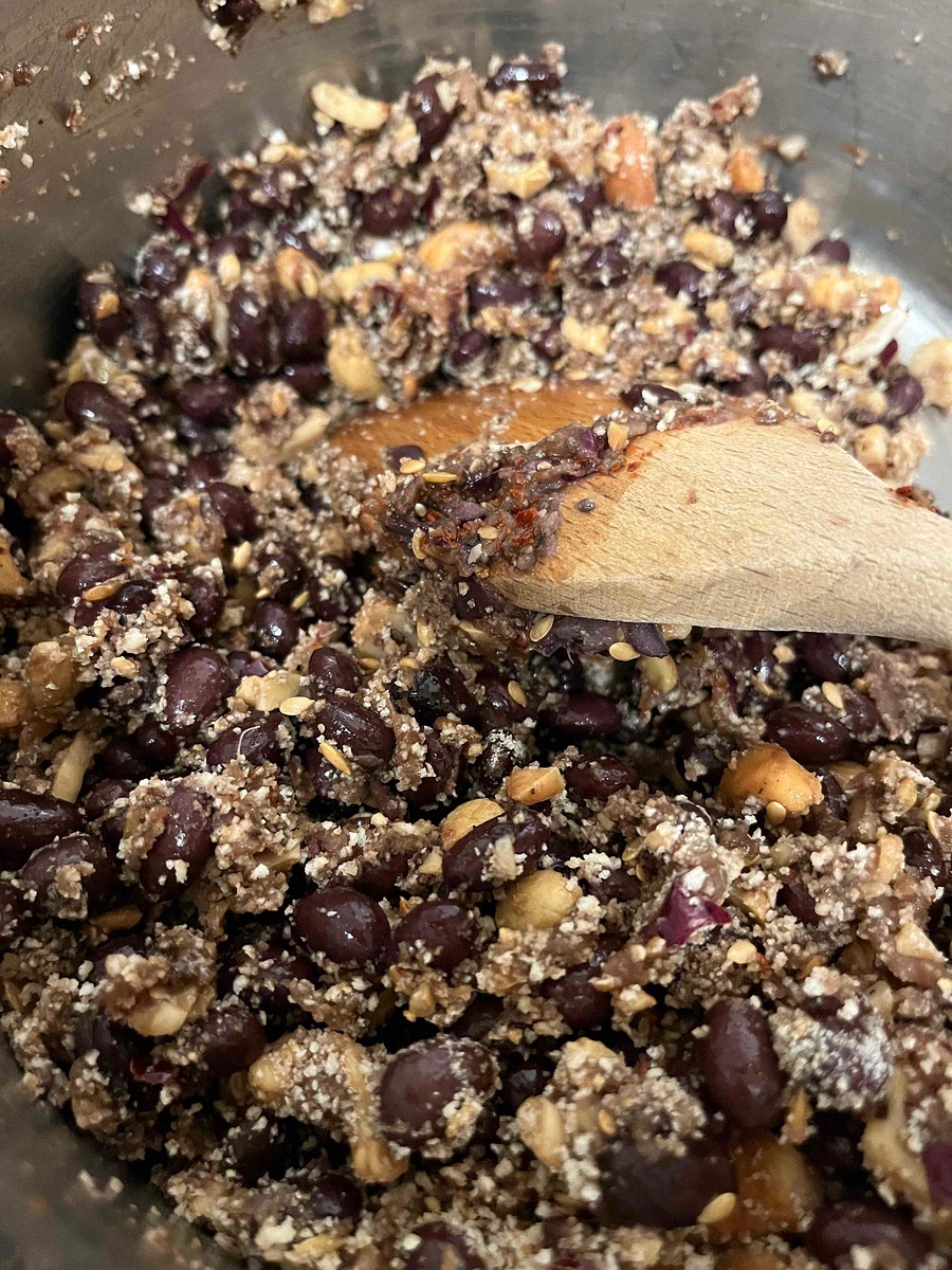 To the beans, add the mixed seeds (I often use a mix of flax and chia or other small seeds) as well as the marmite, Henderson’s Relish, tomato paste, mustard and seasoning and breadcrumbs.