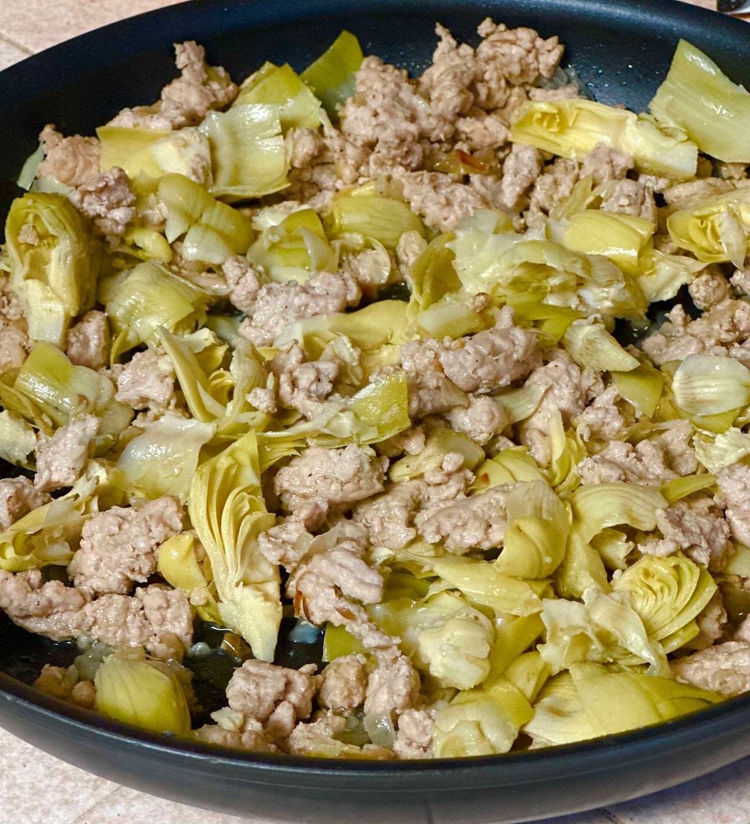 Add the frozen artichoke hearts and sauté until the turkey starts to brown. Remove the pan from the heat, and let cool.
