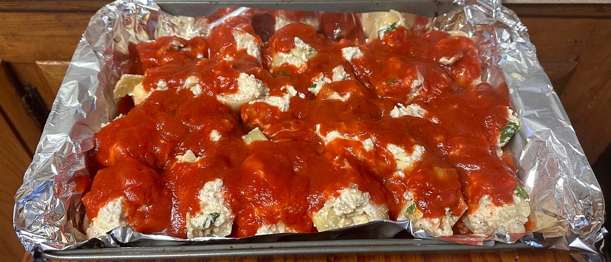 Evenly pour the remaining tomato sauce on top of the shells. Evenly add the mozzarella cheese until all shells are covered.