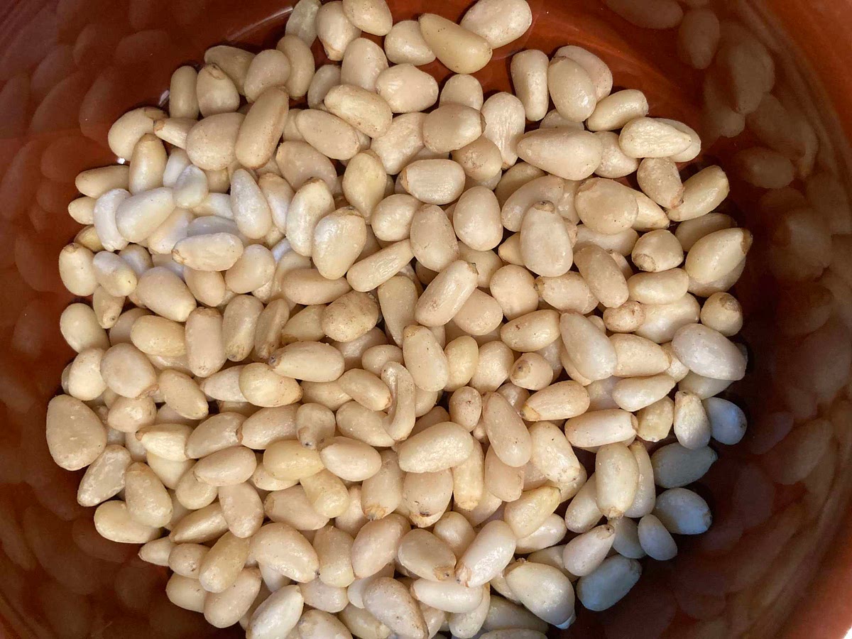 Toast the pine nuts until golden and then set aside.