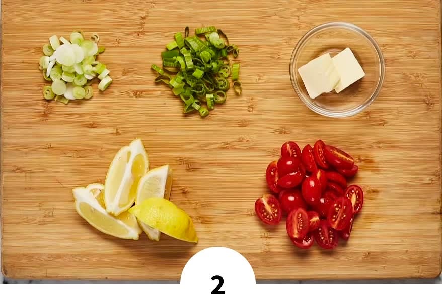 • Meanwhile, bring 2 TBSP butter (4 TBSP for 4 servings) to room temperature. Wash and dry produce. • Quarter lemon. Trim and thinly slice scallions, separating whites from greens. Halve grape tomatoes lengthwise.