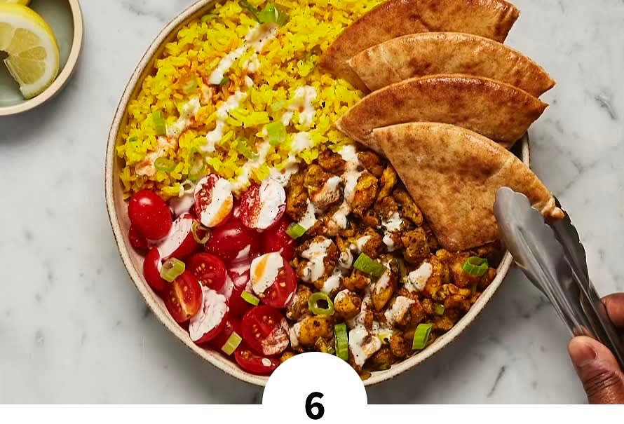 • Once rice is done, fluff with a fork; stir in half the scallion greens. Season with salt and pepper to taste. • Divide rice between bowls. Top with chicken and tomatoes in separate sections; season tomato with a pinch of salt. Drizzle everything with as much white sauce and hot sauce as you like; garnish with remaining scallion greens. Serve with pita and remaining lemon wedges on the side. TIP: We like to scoop up some of the rice, chicken, tomato, and sauces with a pita wedge and eat it all in one bite!