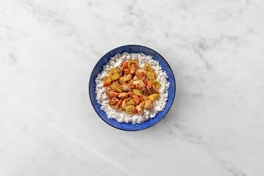 Fluff rice with a fork and divide between plates. A perfect base for a stir-fry.