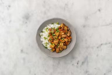 Fluff rice with a fork. Stir in the green onions. Divide between plates and top with main dish of choice. Save some green onions for a garnish if you wish.