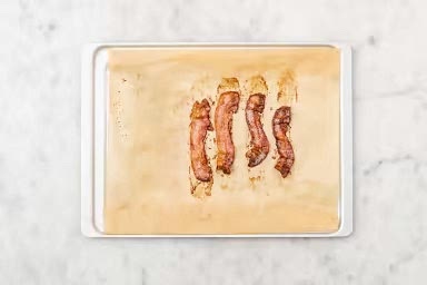 Before starting, preheat the oven to 425˚F. Remove 2 tbsp butter from the fridge and set aside to come up to room temperature. Wash and dry all produce. Arrange bacon strips in a single layer on a parchment-lined baking sheet. Roast bacon in the top of the oven, flipping halfway through, until golden-brown and cooked through, 12-14 min. Using tongs, transfer bacon to a paper towel-lined plate. Carefully transfer bacon fat to a small heat-proof bowl. Reserve.