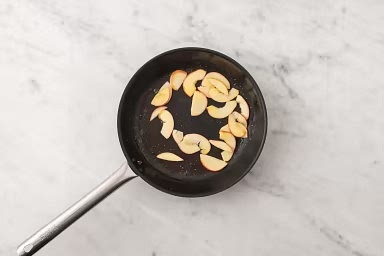 When bacon is done, heat a large non-stick pan over medium-high heat. When the pan is hot, add 1/2 tbsp reserved bacon fat, then apples. Sprinkle 1 tsp sugar over apples. Cook, gently stirring occasionally, until apples are lightly caramelized, 2-3 min. Remove the pan from heat.