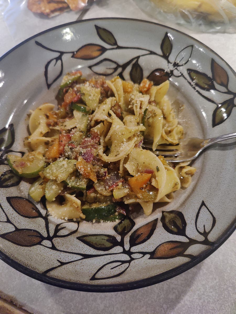 Heat oil and butter in saute pan. Dice peppers, zucchini, and red onion.