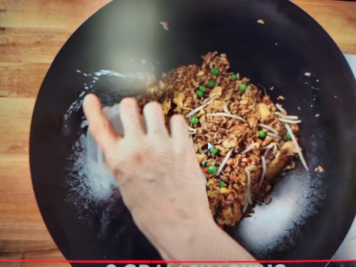 Push everything to the center and add wine around the edges. Stir wine into rice and cook for 20 to 30 sec.