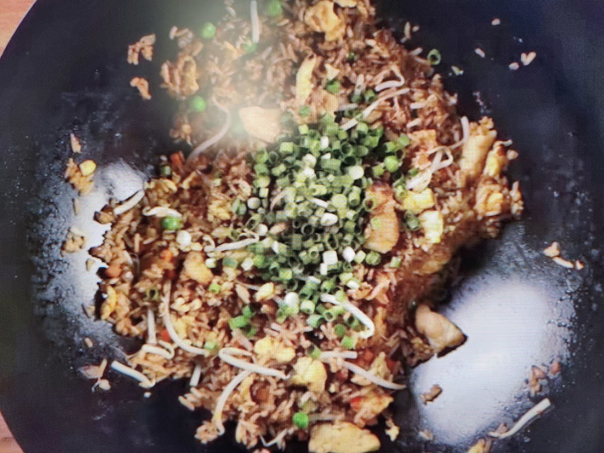 Add sliced green onions and toasted sesame seed oil. Stir everything in.