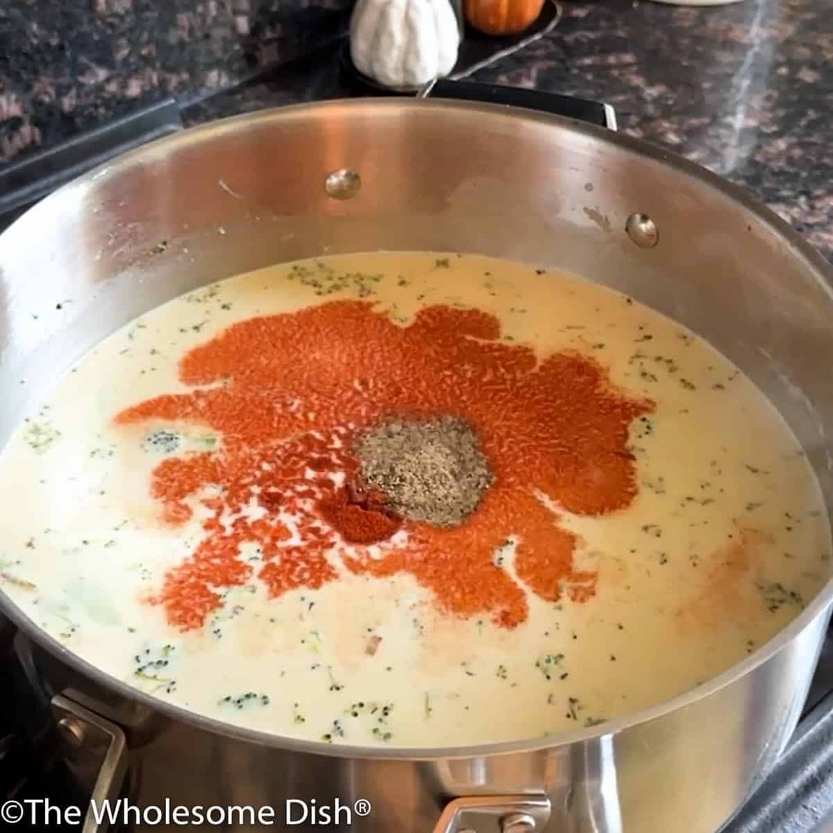 Add the broth, salt, garlic powder, paprika, and pepper. Stir well. Bring the liquid to a simmer. Cook 5 minutes.