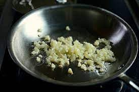 Add some olive oil to a pan and then put chopped garlic on top