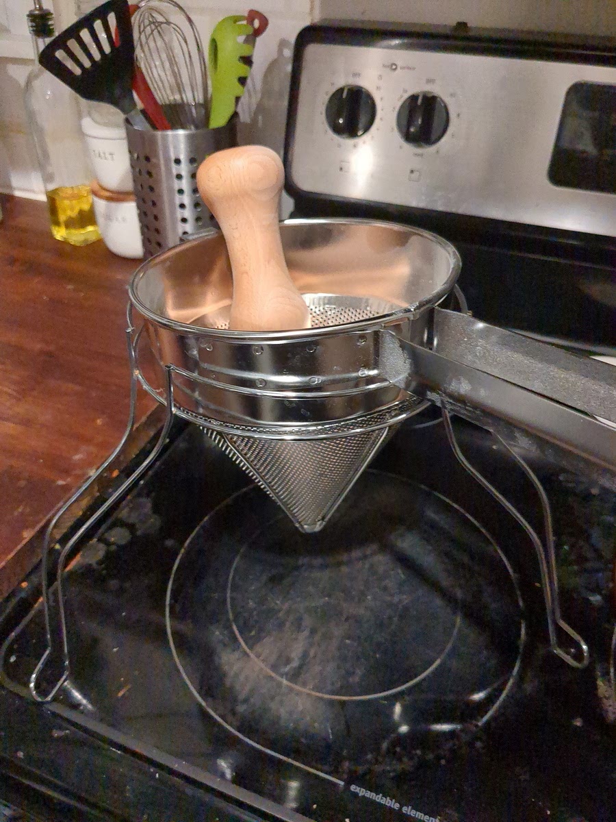 Once the fruit is soft, put it all through a chinios or cone strainer.